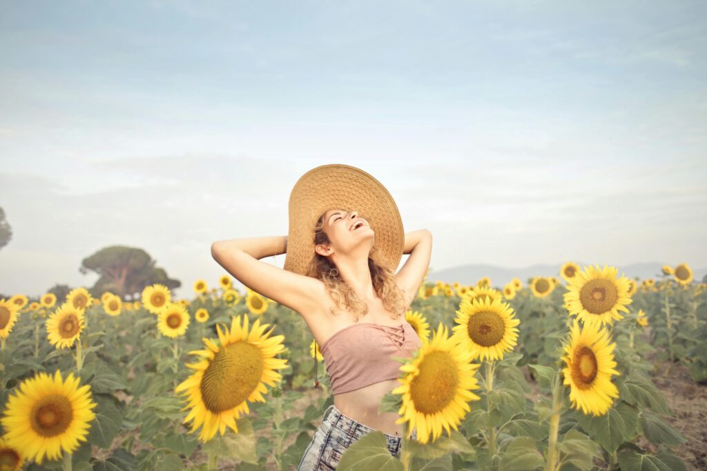 https://www.pexels.com/photo/woman-standing-on-sunflower-field-3764579/